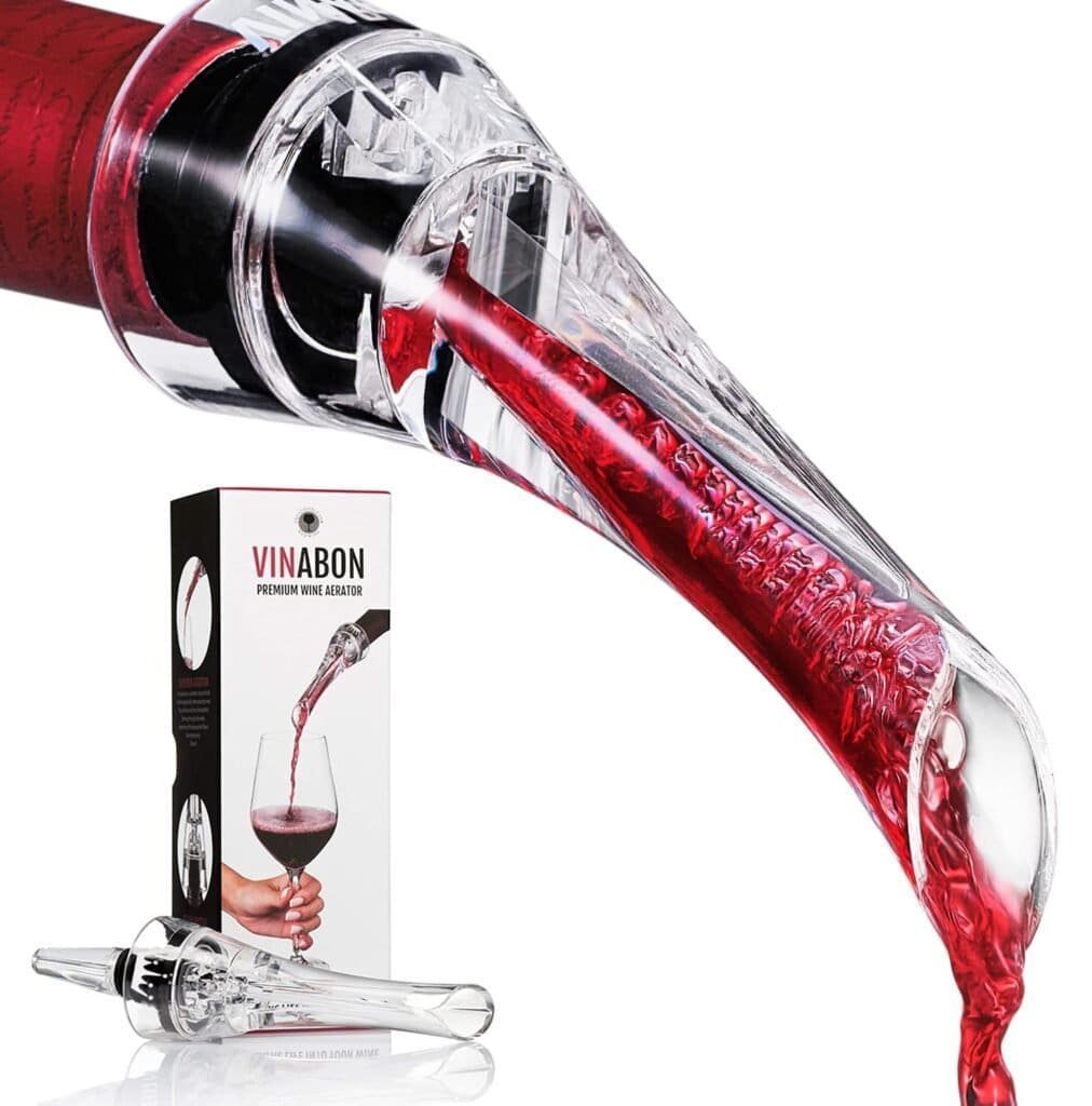 A Vinabon Wine Aerator elegantly decants red wine into a glass, showcasing its transparent design attached to the bottle neck. In the background, a product box proudly displays the "VINABON" brand name, capturing the essence of this 2018 aerator wine pourer.